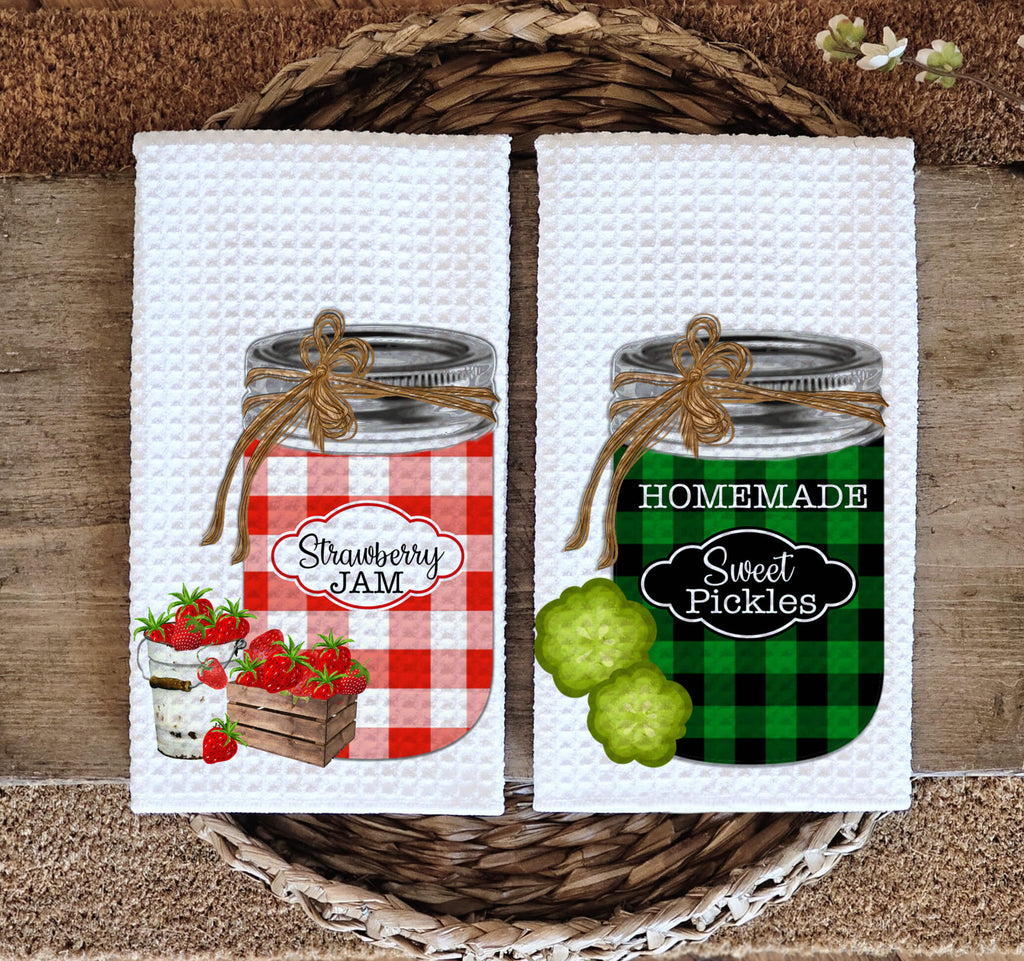 Farmhouse kitchen towel set featuring rustic mason jars with strawberry jam and homemade sweet pickles, designed with vintage gingham patterns. Absorbent waffle weave fabric, perfect for country kitchens, homesteaders, and farmhouse decor lovers