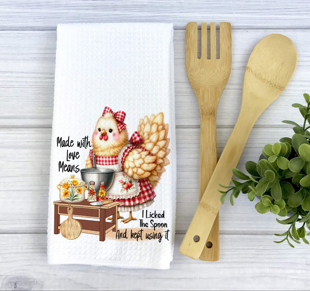 Farmhouse chicken kitchen towel featuring a rustic hen in a red gingham apron, standing by a cooking station with cooking utensils and ingredients. Cute and funny country-style kitchen decor - Personalized Kreation