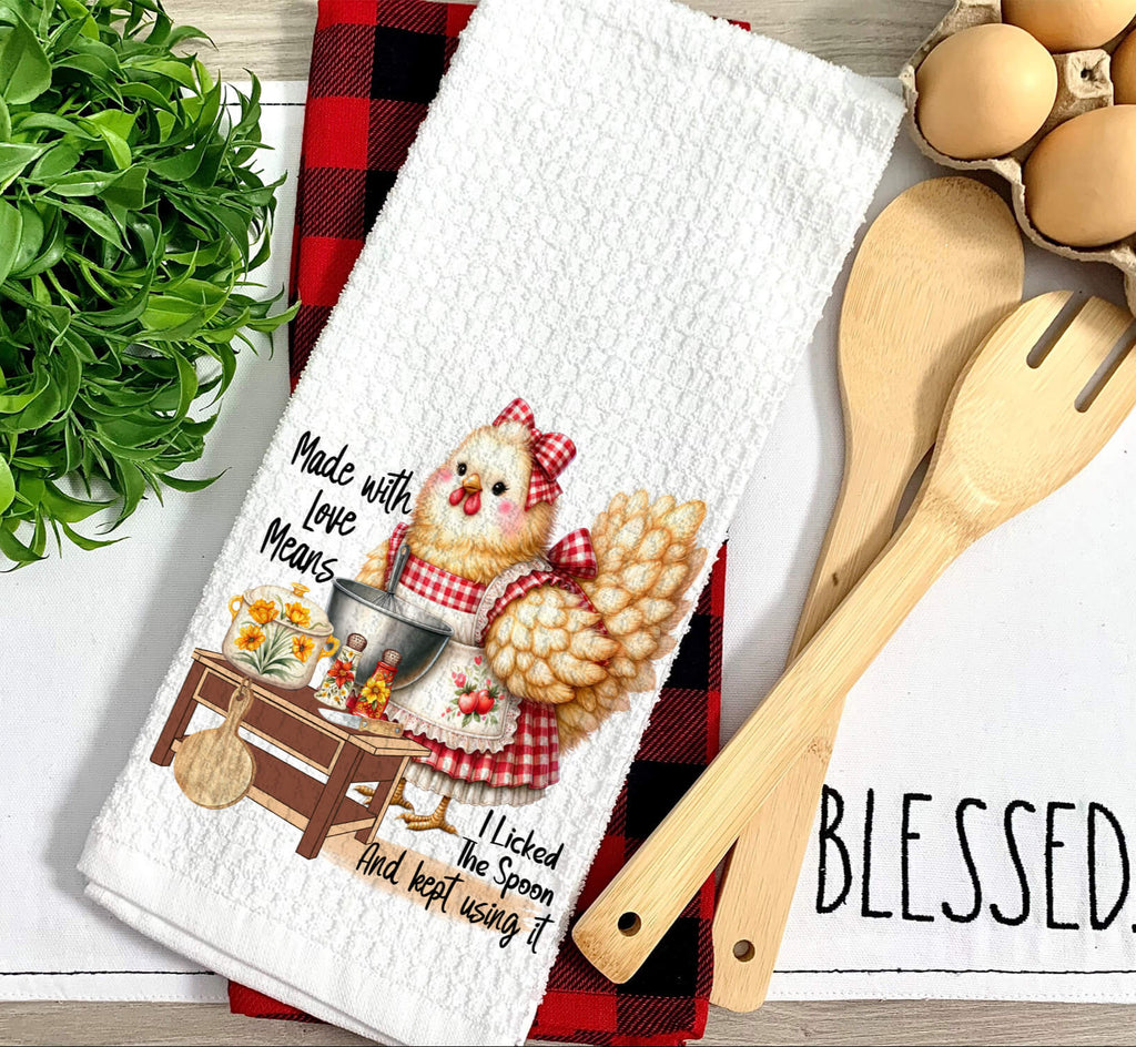 Farmhouse chicken kitchen towel featuring a rustic hen in a red gingham apron, standing by a cooking station with cooking utensils and ingredients. Cute and funny country-style kitchen decor - Personalized Kreation