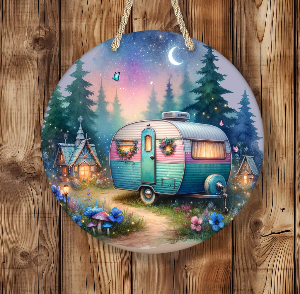 Whimsical hanging round sign featuring a retro teal and pink camper with wreaths on the doors, parked on a glowing forest path under a twilight sky with stars, crescent moon, fireflies, and woodland fairy houses lit warmly in the background - Personalized Kreation