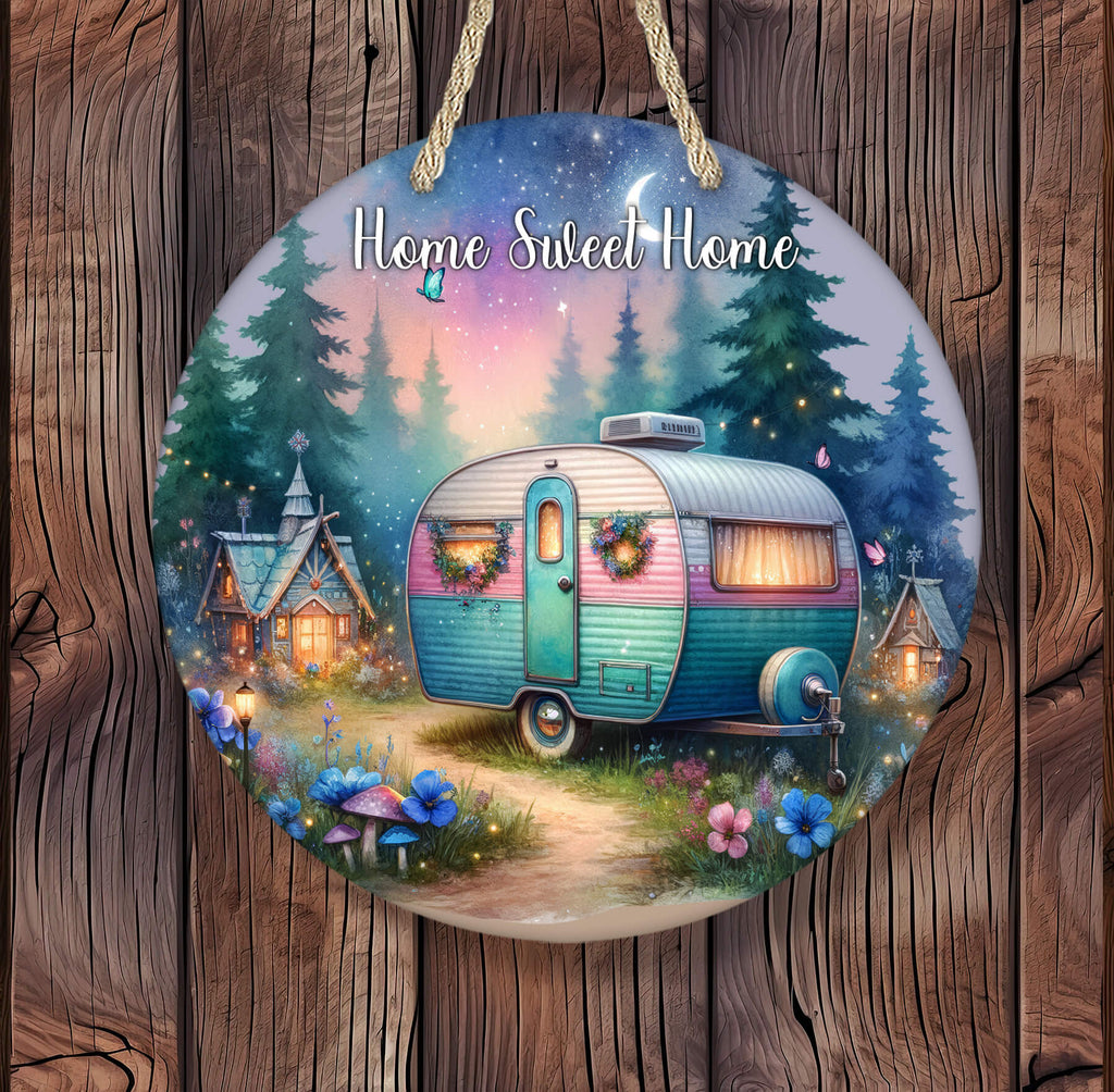 Whimsical hanging round sign featuring a retro teal and pink camper with wreaths on the doors, parked on a glowing forest path under a twilight sky with stars, crescent moon, fireflies, and woodland fairy houses lit warmly in the background - Personalized Kreation