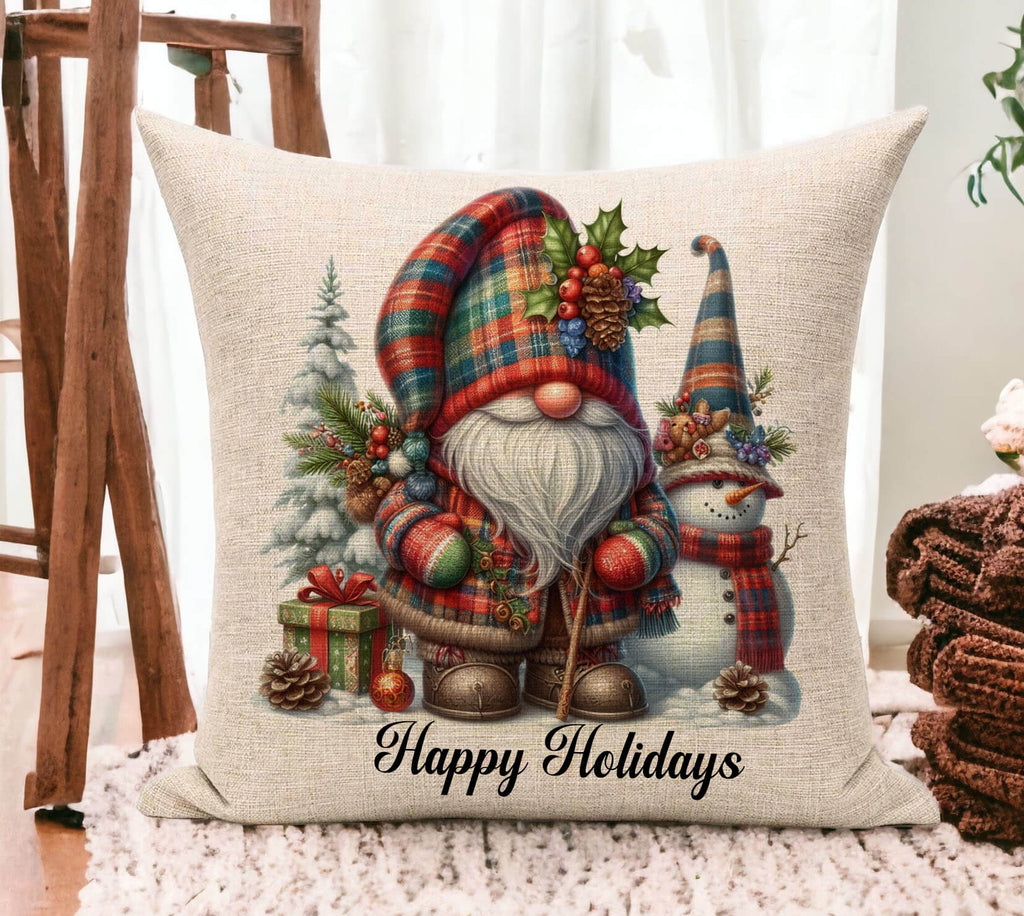 Decorative pillow with Christmas-themed design featuring a gnome and snowman, with 'Happy Holidays' text.
