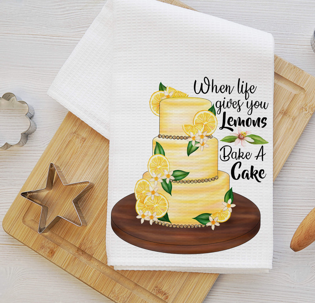 Lemon Cake Kitchen Towel - A beautifully designed white tea towel featuring a vibrant lemon-adorned cake with the phrase 'When Life Gives You Lemons, Bake A Cake.' Perfect for farmhouse decor, baking lovers, and unique kitchen gifts - Personalized Kreation