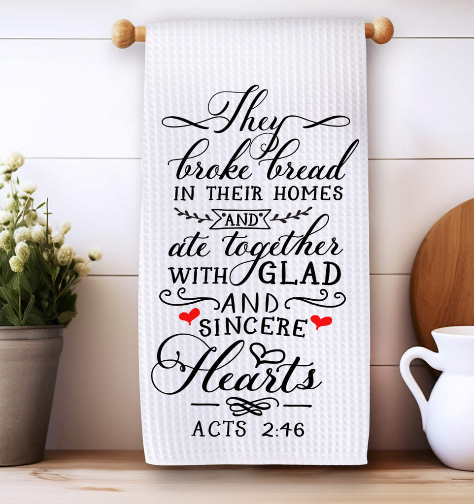 Christian kitchen towel featuring Acts 2:46 Bible verse, 'They broke bread in their homes and ate together with glad and sincere hearts.' Made from absorbent cotton, perfect for farmhouse kitchen décor, religious gifts, or inspirational home accents - Personalized Kreation