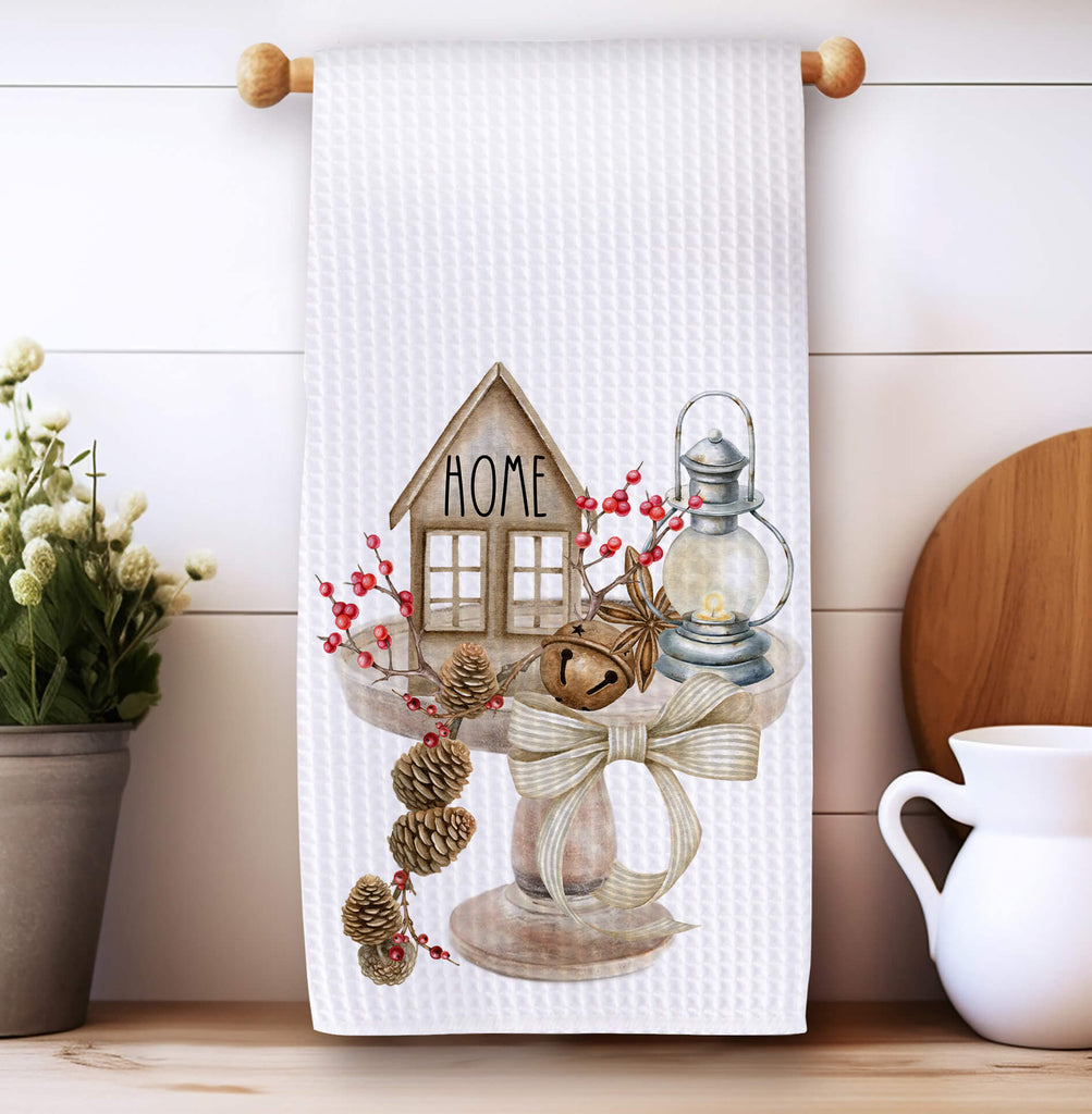 Rustic farmhouse kitchen towel featuring a cozy home design with pinecones, a lantern, and tiered tray décor. Perfect for vintage cottagecore and neutral country kitchen styling - Personalized Kreation