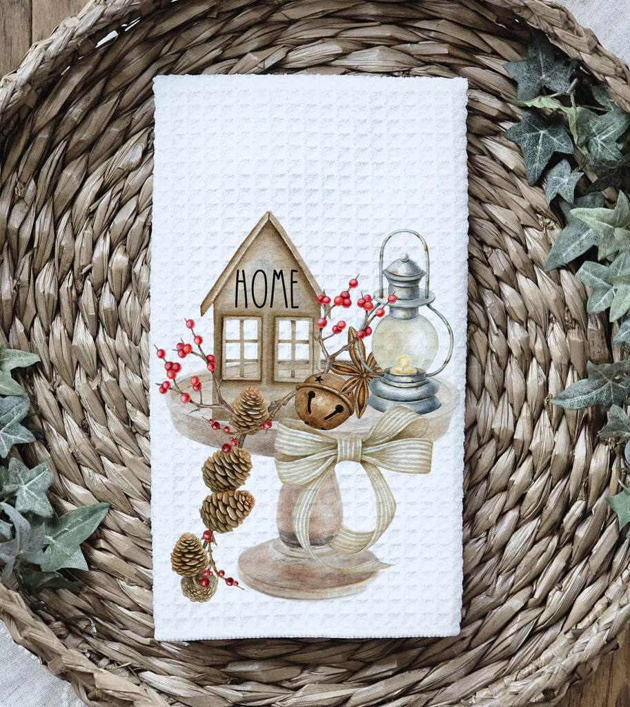 Rustic farmhouse kitchen towel featuring a cozy home design with pinecones a lantern, and tiered tray décor. Perfect for vintage cottagecore and neutral country kitchen styling - Personalized Kreation