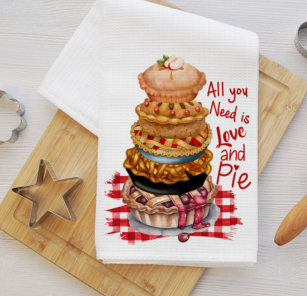 Funny baking kitchen towel featuring a stack of delicious pies, rustic gingham background, and the quote All You Need is Love and Pie Made from absorbent waffle weave fabric perfect for farmhouse kitchens, pie lovers, and rustic kitchen decor | Personalized Kreation