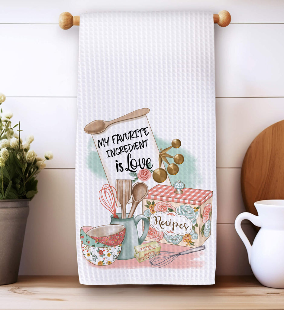 Floral kitchen towel with 'My Favorite Ingredient is Love' quote, featuring vintage baking utensils, recipe box, and farmhouse-style design. Absorbent waffle weave fabric, perfect for baking lovers, farmhouse kitchens, and heartfelt cooking gifts - Personalized Kreation