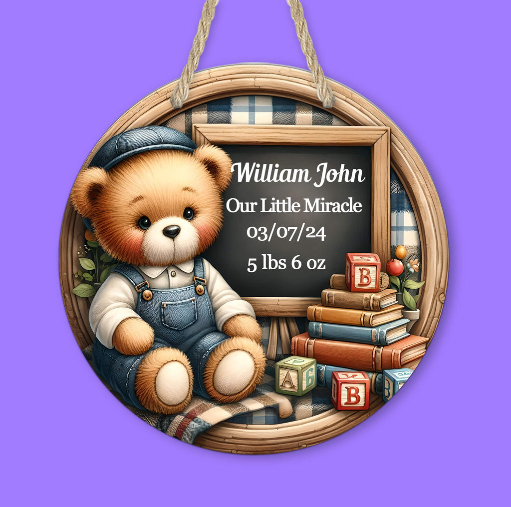 personalized baby boy birth announcement sign featuring a teddy bear in blue overalls sitting next to a chalkboard displaying baby's name, birth date, and weight. decorated with books, alphabet blocks, and a cozy plaid background, perfect for nursery decor or a newborn keepsake - Personalized Kreation