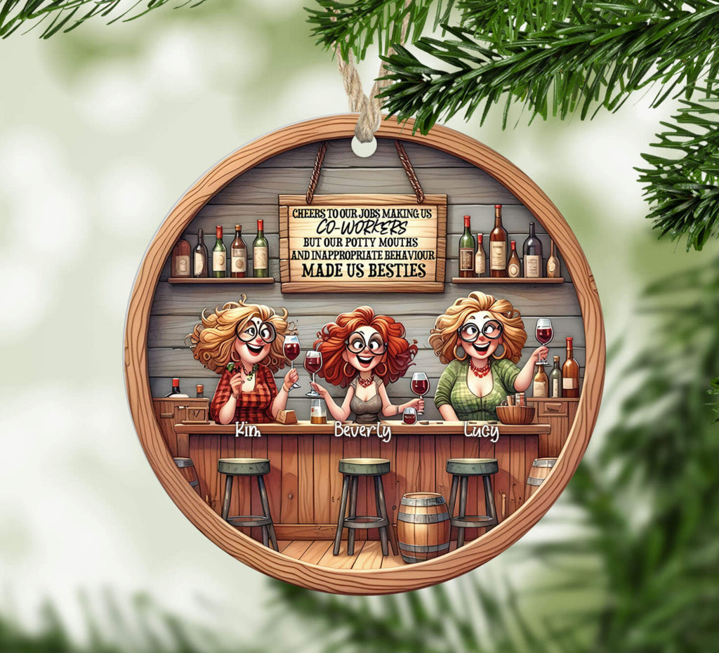 Decorative Christmas ornament with cartoon barmaids and festive text, hanging on a tree.