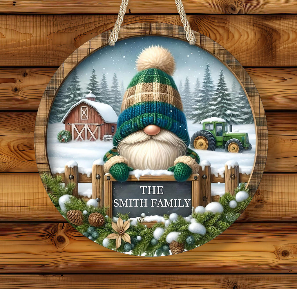 Decorative sign with a gnome, barn, and tractor in a snowy landscape on a wooden background.