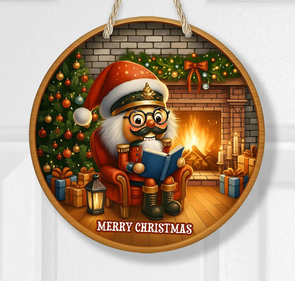 Decorative Christmas ornament with a cartoon Nutcracker reading a book by a fireplace.