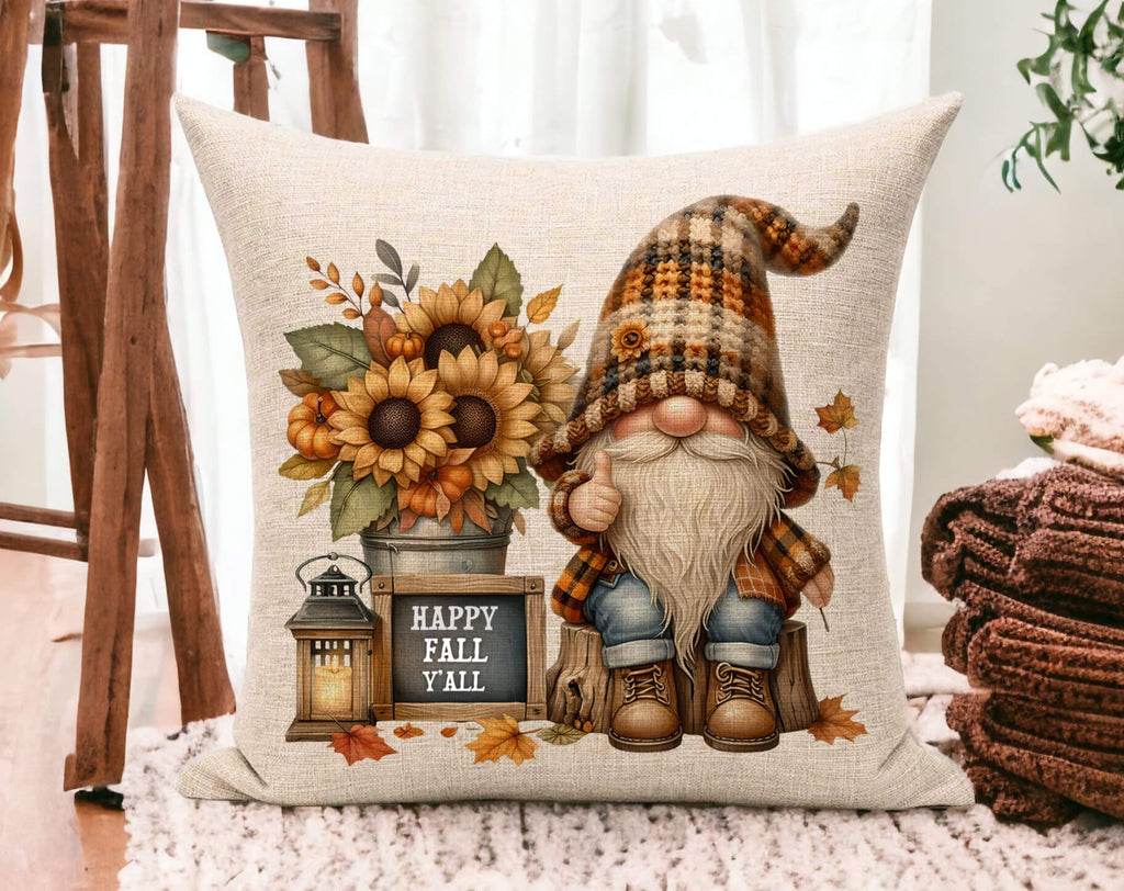 Fall pillow with gnome in plaid hat, sunflowers, pumpkins, rustic lantern, and 'Happy Fall Y’all' chalkboard sign on cream linen fabric