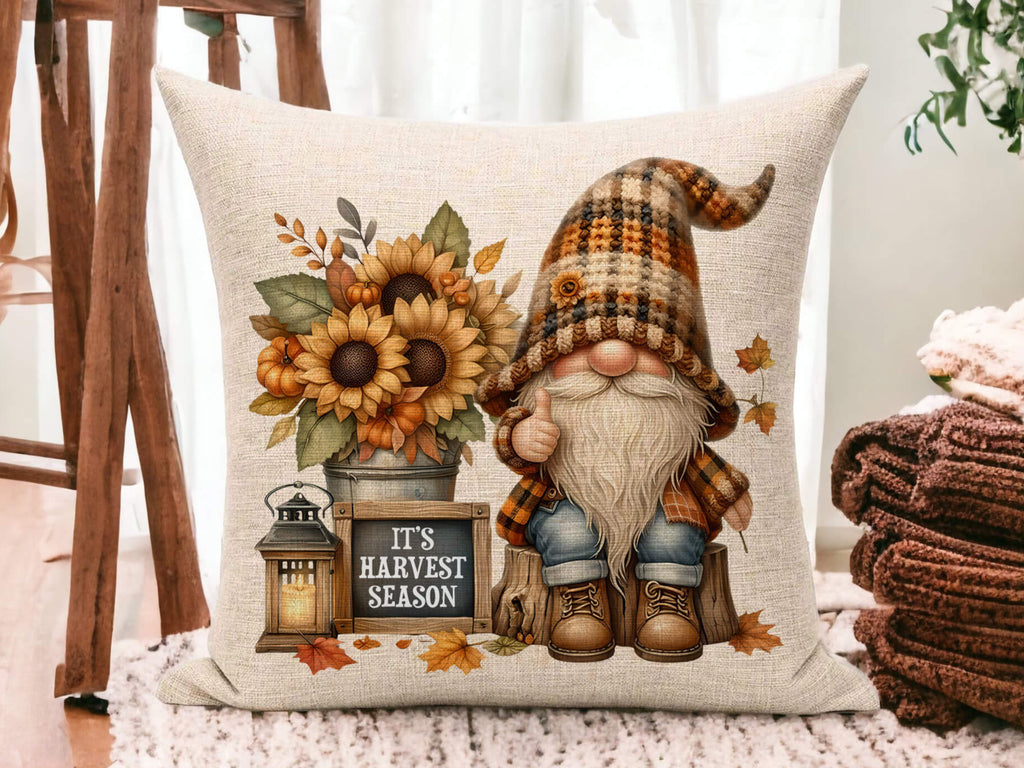 Fall pillow with gnome in plaid hat, sunflowers, pumpkins, rustic lantern, and 'Happy Fall Y’all' chalkboard sign on cream linen fabric
