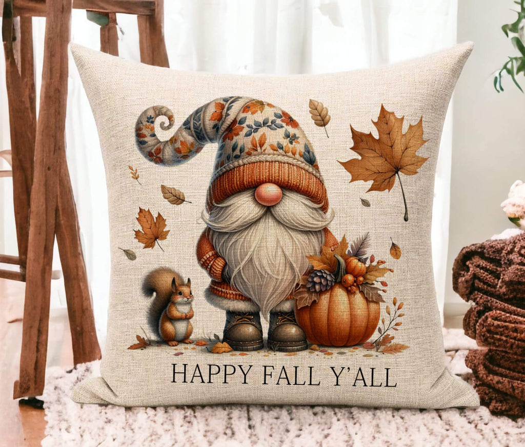 Decorative pillow with a gnome, pumpkin, and leaves design on a wooden floor.