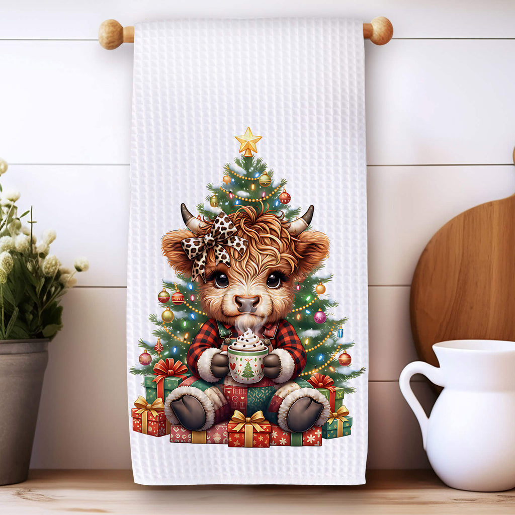 Towel with a Christmas design of a bear and tree on a kitchen counter.
