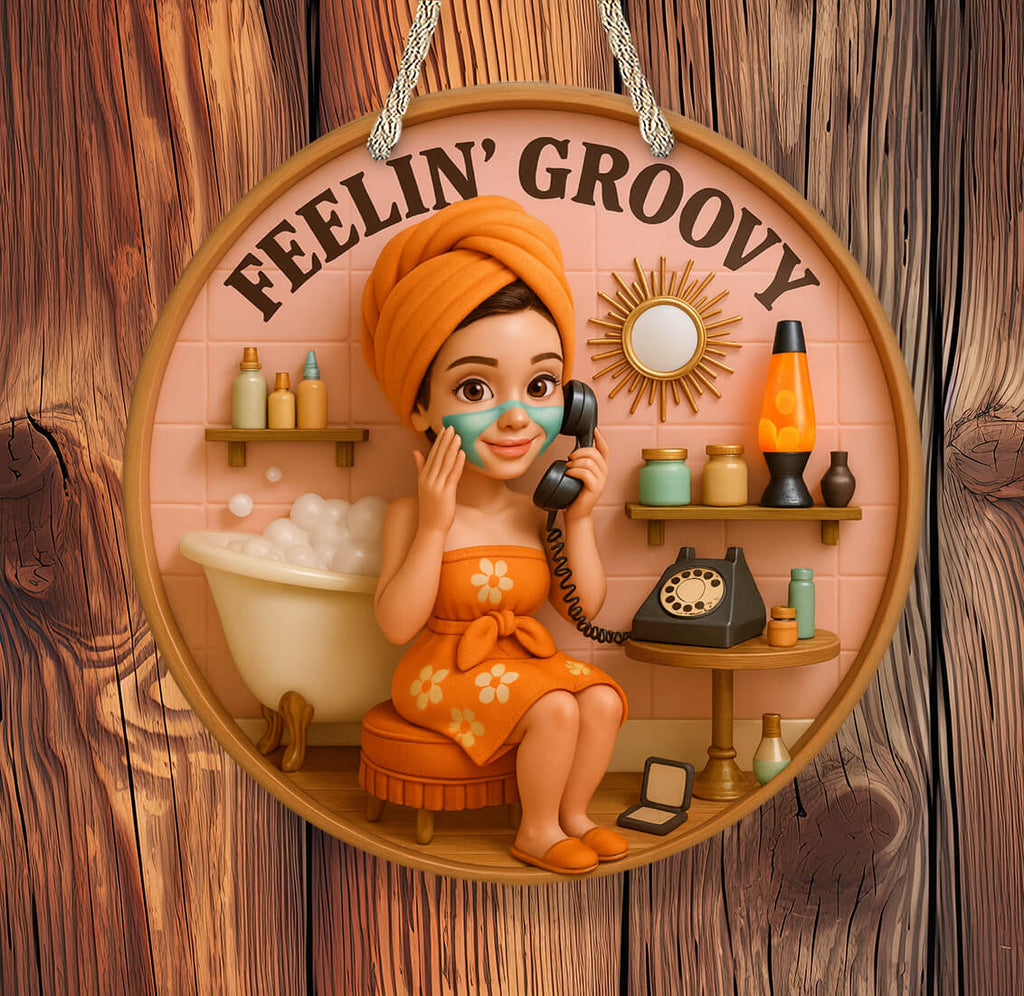 Decorative sign with a woman in an orange dress and towel, holding a phone, with 'Feelin' Groovy' text on a wooden background.