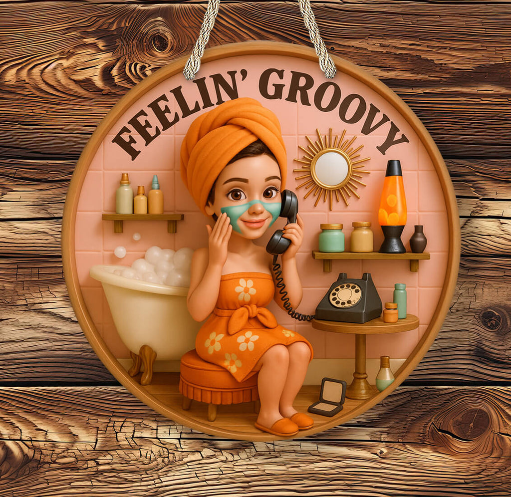 Decorative sign with a woman in an orange dress and towel, holding a phone, with 'Feelin' Groovy' text on a wooden background.