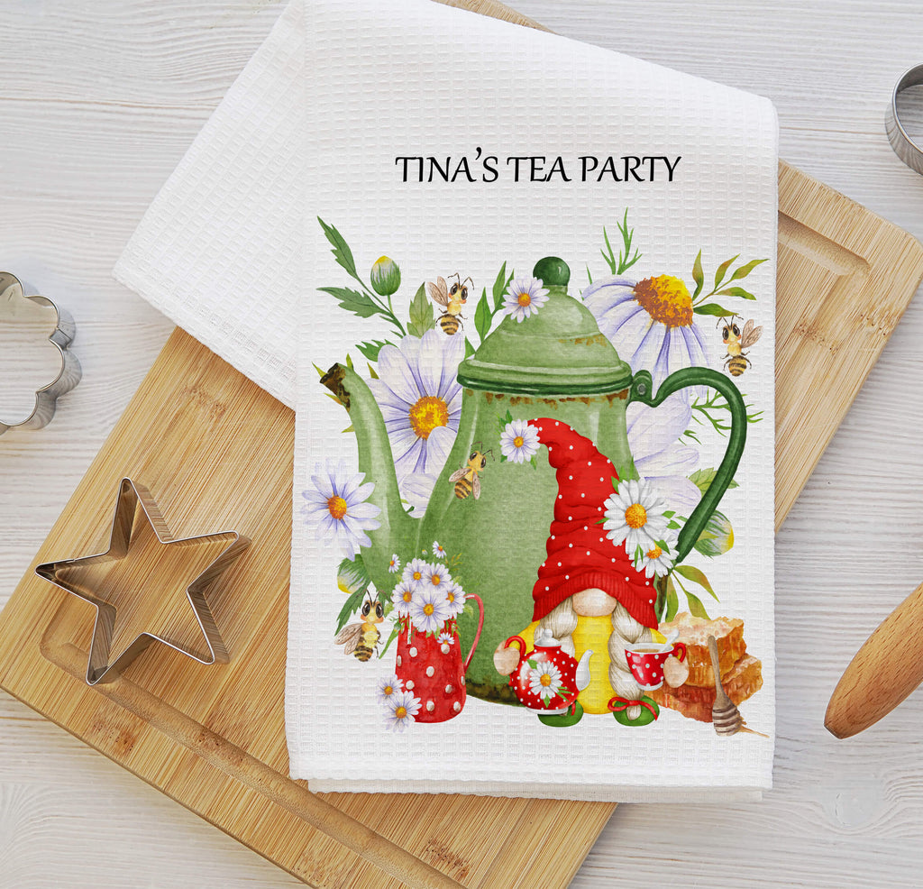 Personalized tea party kitchen towel featuring a cute gnome, floral teapot, wildflowers, and honey bees. Made from absorbent waffle weave fabric, perfect for farmhouse kitchens, tea lovers, and rustic tea-themed decor - Personalized Kreation