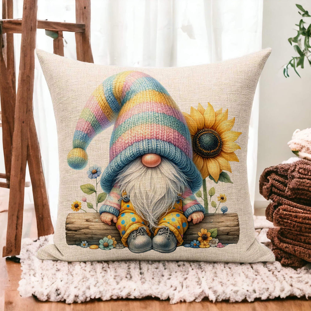Decorative pillow with a gnome and sunflower design on a wooden floor.