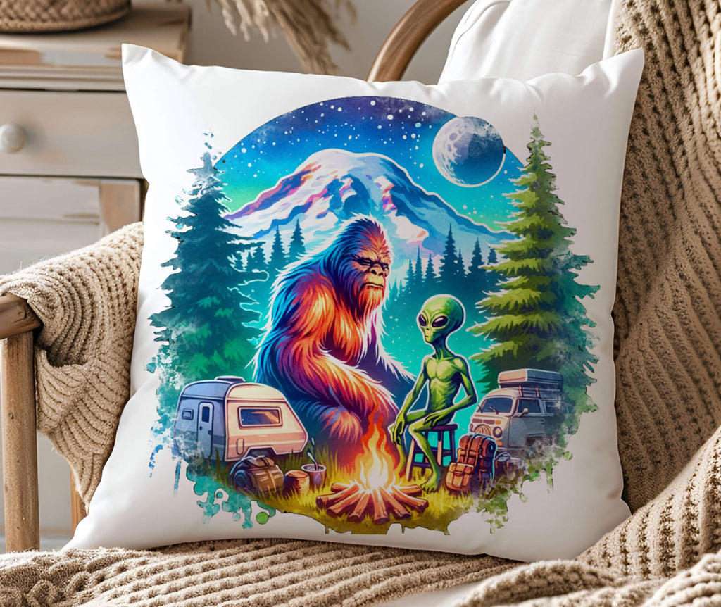 A funny Bigfoot and alien camping pillow featuring a retro-style design of Sasquatch and an alien roasting marshmallows by a campfire, surrounded by pine trees, under a cosmic starry sky with a glowing UFO in the background. The 18x18-inch pillow is available in white canvas  with a hidden zipper closure perfect for sci-fi lovers cryptid fans  and outdoor enthusiasts - Personakized Kreation