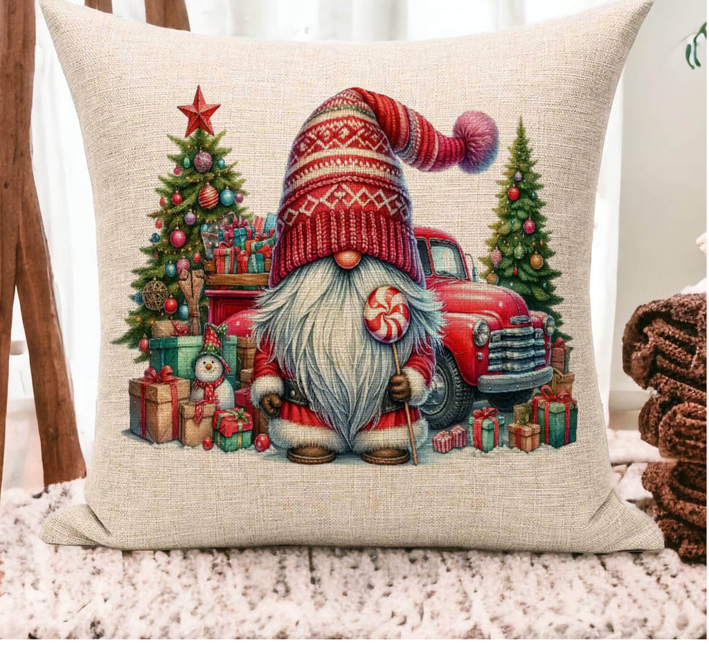 Decorative pillow with a Christmas-themed design featuring a gnome, tree, and truck.