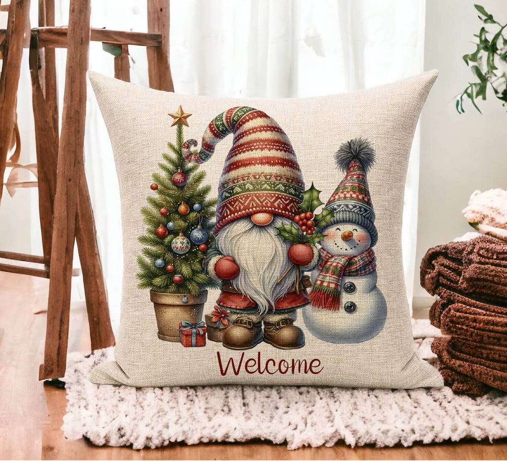 Decorative pillow with Christmas-themed design featuring a gnome and snowman, placed on a surface.