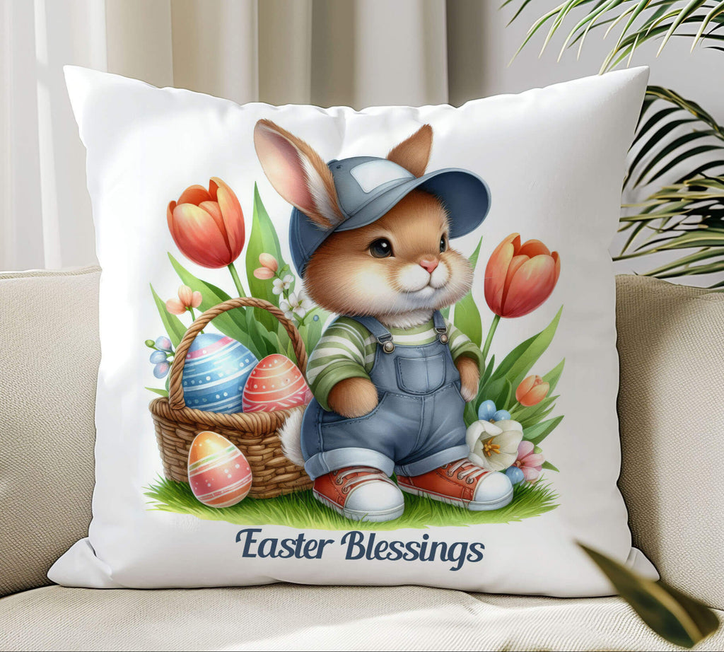 A charming Easter Bunny Pillow featuring a cute bunny wearing overalls and a cap, sitting among vibrant tulips with a woven Easter basket filled with decorated eggs. The soft pillow is placed outdoors on a cozy blanket, surrounded by pastel-colored eggs and fresh spring flowers, creating a warm and inviting springtime ambiance. Perfect for Easter home decor, farmhouse accents, or a delightful gift for bunny lovers - Personalized Kreation