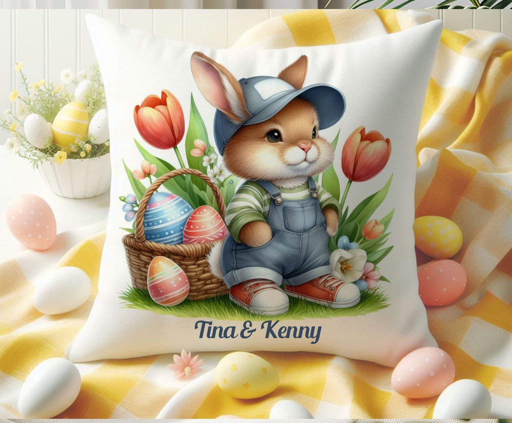 A charming Easter Bunny Pillow featuring a cute bunny wearing overalls and a cap, sitting among vibrant tulips with a woven Easter basket filled with decorated eggs. The soft pillow is placed outdoors on a cozy blanket, surrounded by pastel-colored eggs and fresh spring flowers, creating a warm and inviting springtime ambiance. Perfect for Easter home decor, farmhouse accents, or a delightful gift for bunny lovers - Personalized Kreation