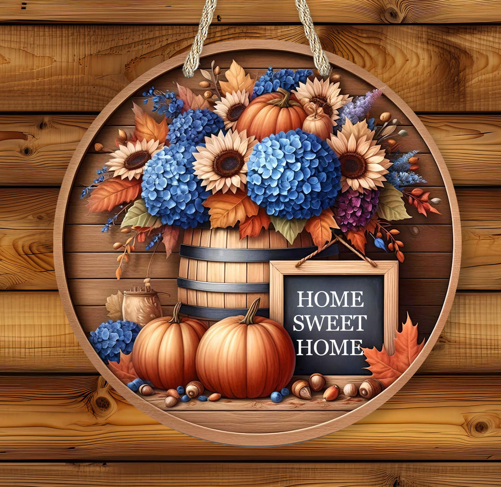 Decorative sign with pumpkins, flowers, and 'Home Sweet Home' sign on a wooden background