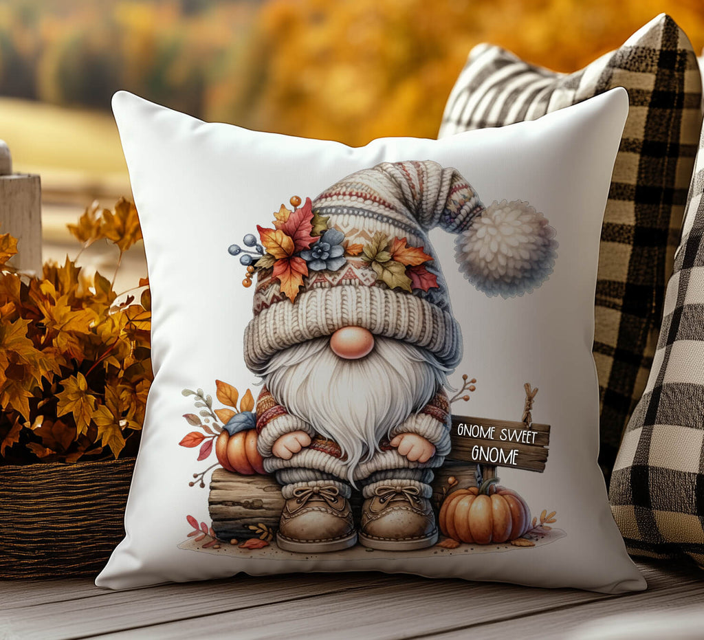 Decorative pillow with a gnome illustration and autumn elements on a wooden surface.