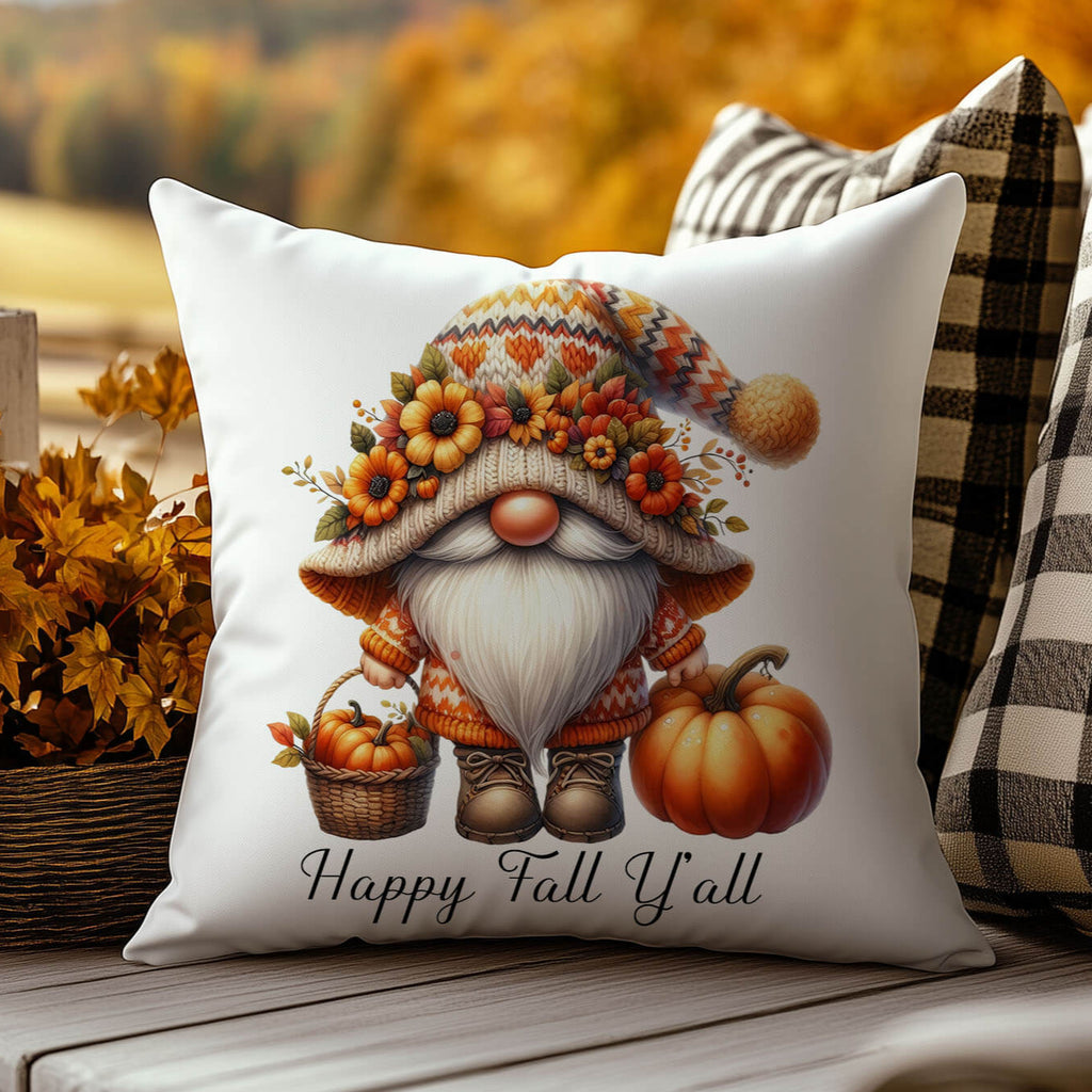 Decorative pillow with a fall-themed gnome design and 'Happy Fall Y'all' text, placed on a wooden surface with autumn leaves in the background.