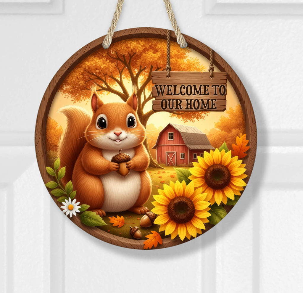Decorative sign with a squirrel, sunflowers, and a barn, featuring 'Welcome to Our Home' text.