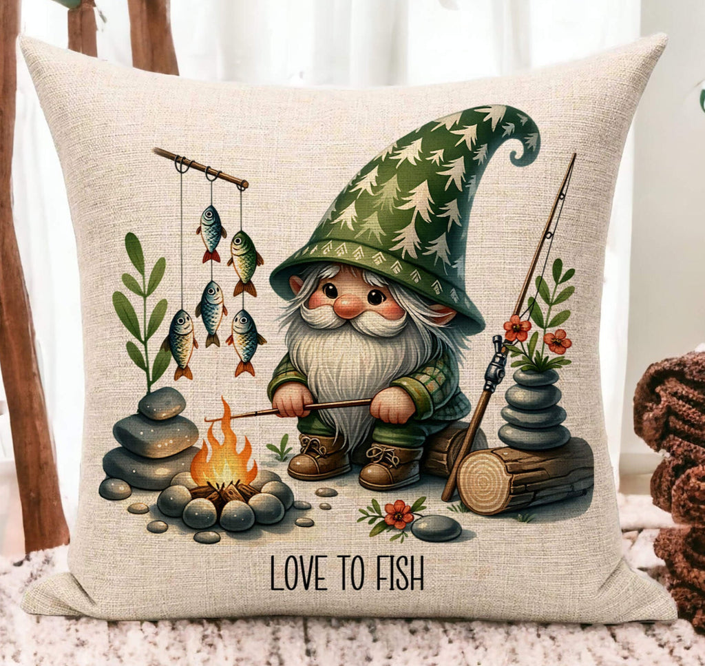 A personalized fishing gnome pillow featuring a gnome sitting by a campfire with fishing poles and fish. The pillow is 18x18 inches, available in white canvas or beige linen, with a hidden zipper closure. Ideal for fishing lovers, rustic cabin decor, or camping enthusiasts. Perfect for adding a touch of the great outdoors to any space - Personalized Kreation