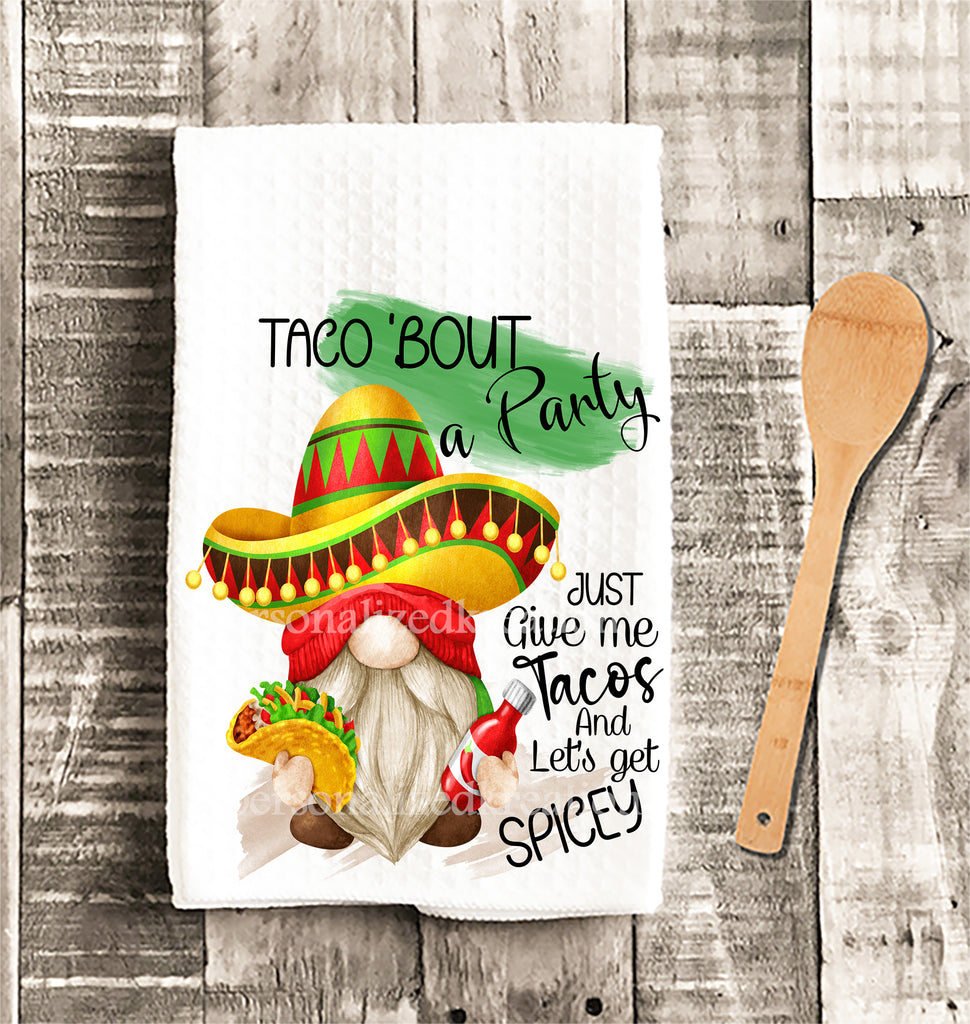 taco kitchen towel gnome wearing sombrero holds taco and hot sauce colorful vibrant made of microfiber waffle weave pattern sixteen by twenty four inches image printed on both ends of towels reads give me tacos lets get spicy