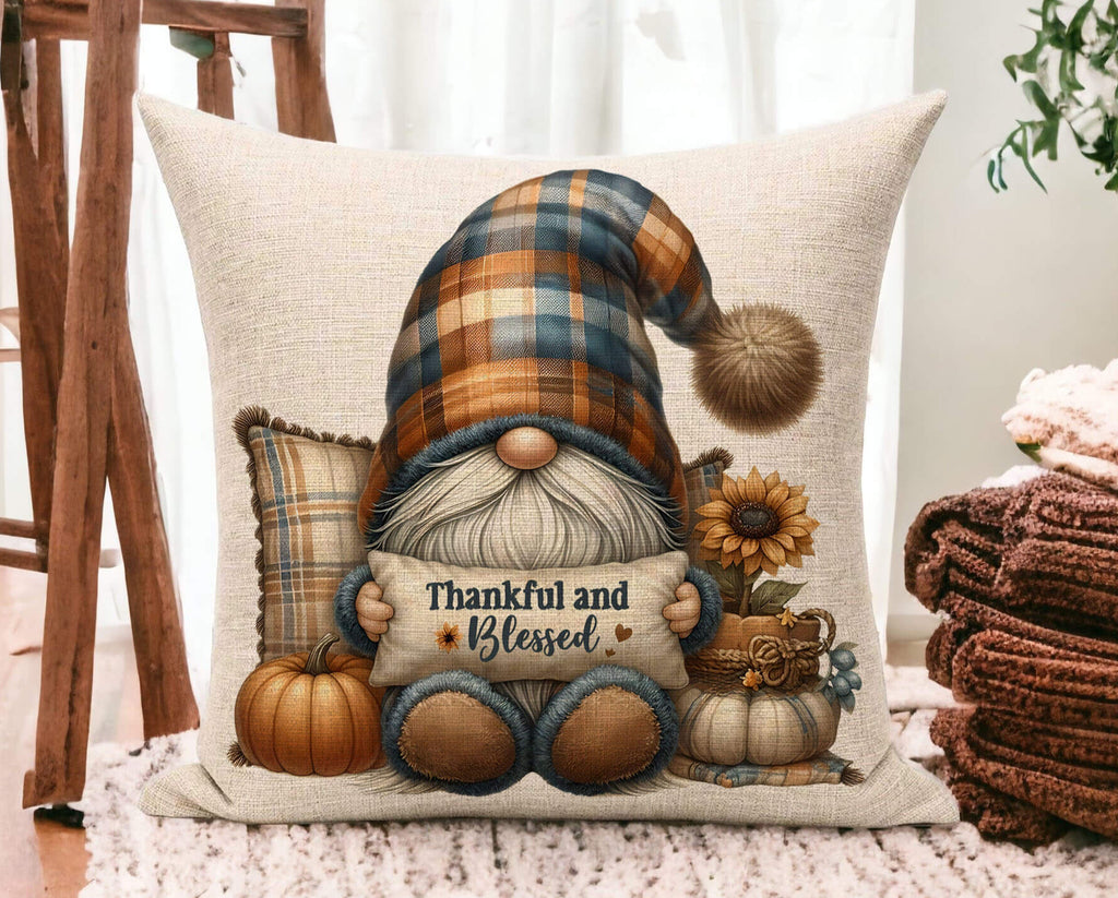 Decorative pillow with a gnome holding a 'Thankful and Blessed' sign, surrounded by pumpkins and sunflowers.