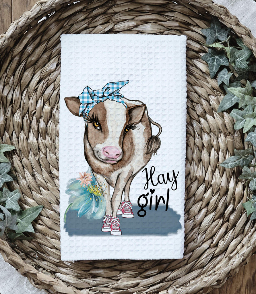 Farmhouse cow kitchen towel featuring a cute cow wearing a blue bandana and sneakers with "Hay Girl" text, perfect for rustic country decor and farmhouse kitchen style. Made from high-quality absorbent fabric, ideal for drying dishes or decorative use - Personalized Kreation