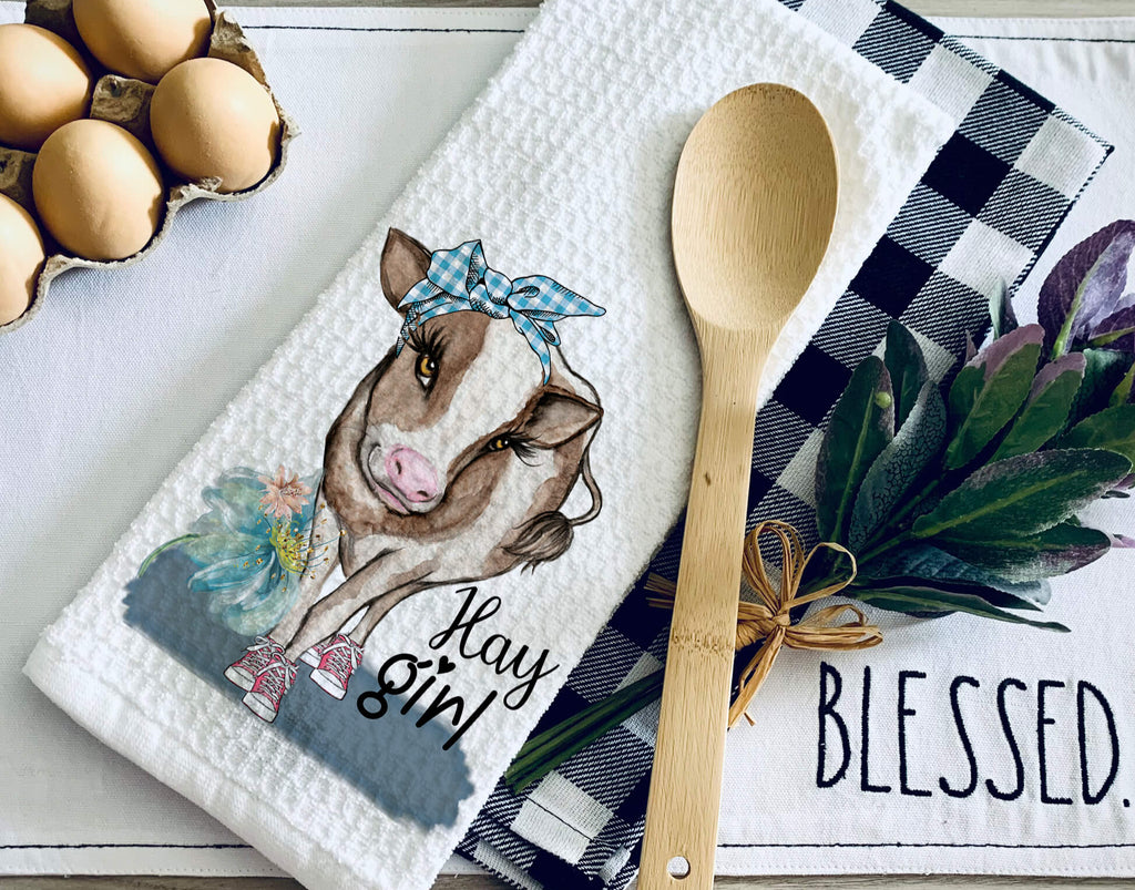 Farmhouse cow kitchen towel featuring a cute cow wearing a blue bandana and sneakers with "Hay Girl" text, perfect for rustic country decor and farmhouse kitchen style. Made from high-quality absorbent fabric, ideal for drying dishes or decorative use - Personalized Kreation