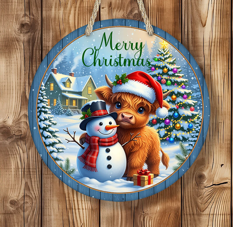 Round Christmas-themed sign with a cow, snowman, and tree on a wooden background