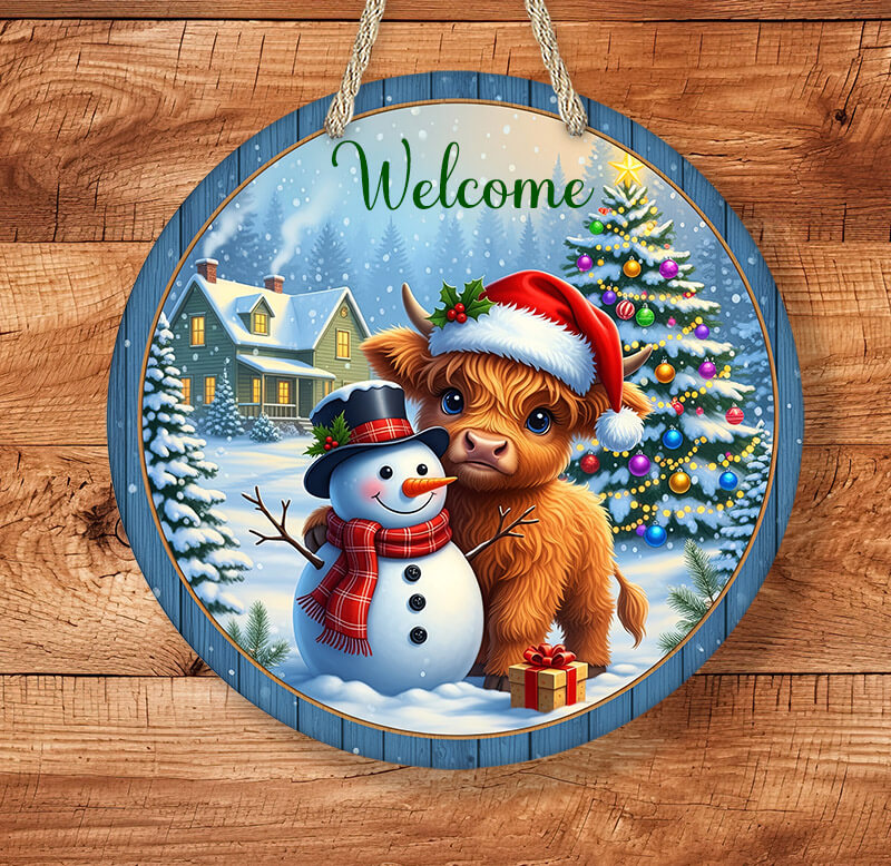 Round Christmas-themed sign with a cow, snowman, and tree on a wooden background