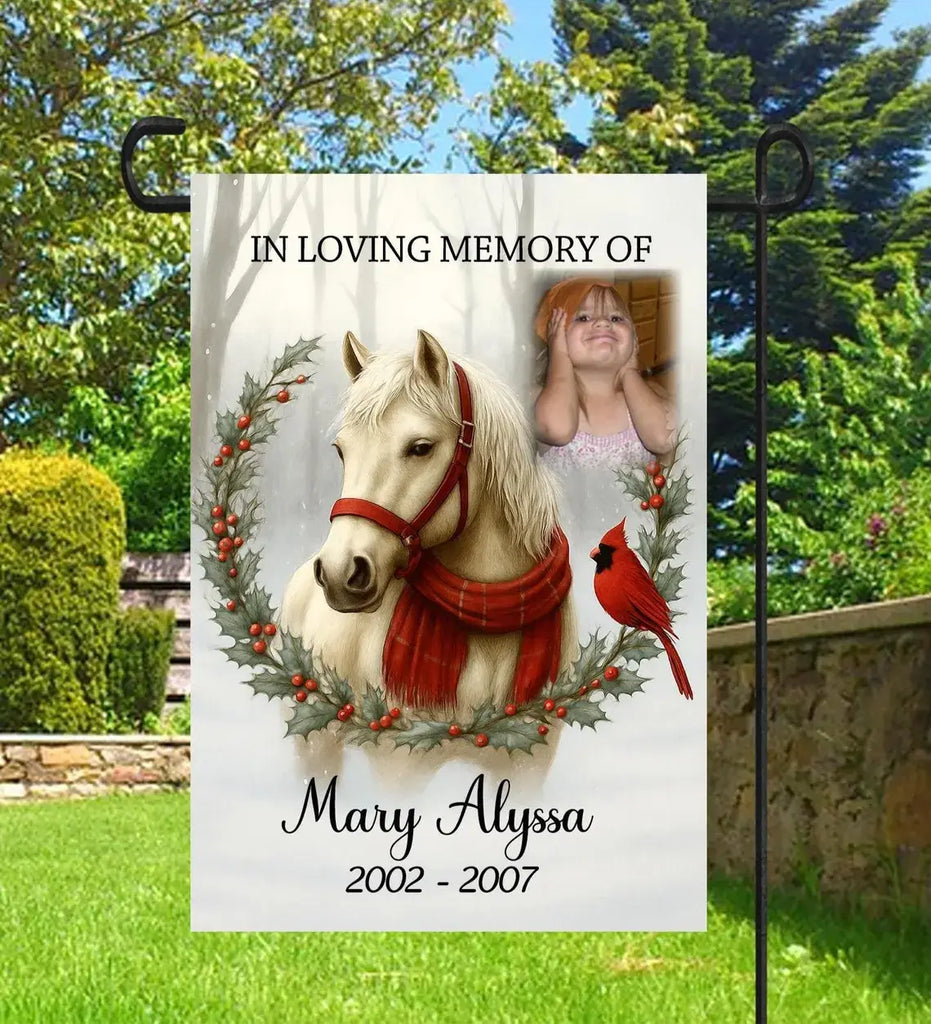 Memorial garden flag with horse, child's photo, and cardinal bird in a wreath.