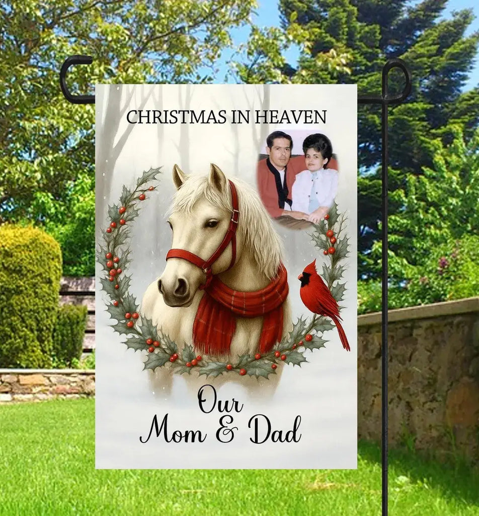 Memorial garden flag with horse, red cardinal, and photo of a couple with text 'Christmas in Heaven, Our Mom & Dad' in a garden setting.