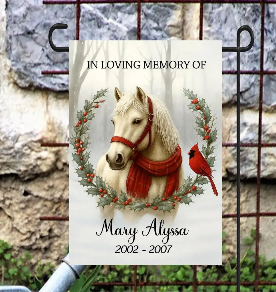 Memorial sign for a horse named Mary Alyssa with a red scarf and cardinal, against a stone wall background.