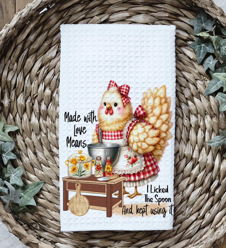 Farmhouse chicken kitchen towel featuring a rustic hen in a red gingham apron, standing by a cooking station with cooking utensils and ingredients. Cute and funny country-style kitchen decor - Personalized Kreation