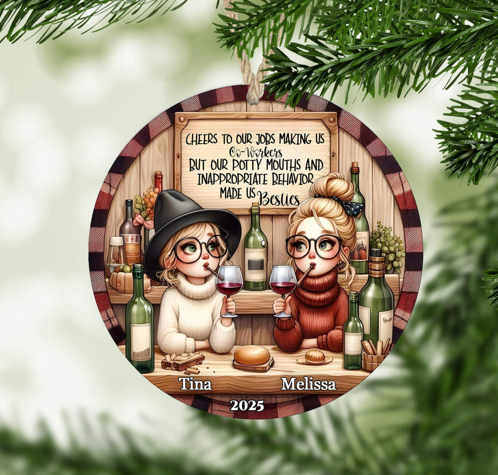 Decorative Christmas ornament with two people holding wine glasses and text on a tree branch.