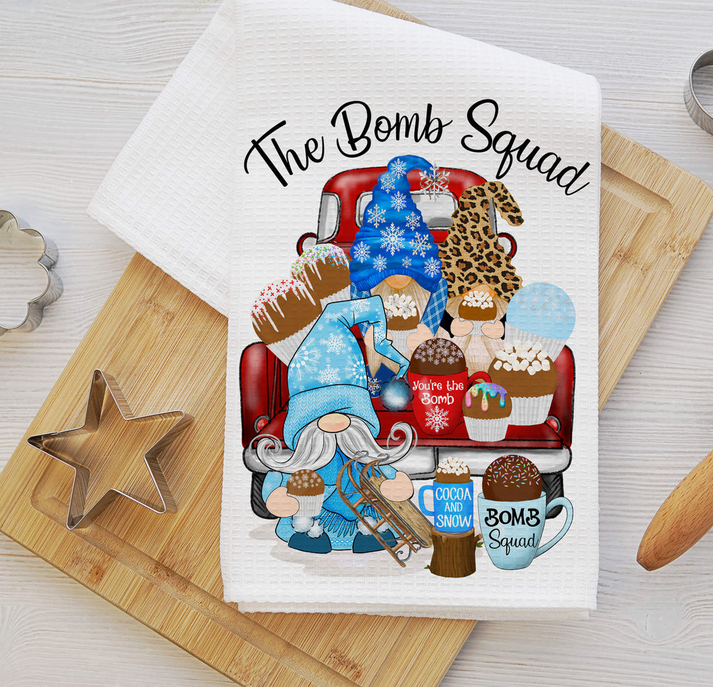Hot Cocoa Bomb Squad kitchen towel featuring winter gnomes, hot chocolate bombs, and festive holiday decor. Made from absorbent waffle weave fabric, perfect for Christmas baking, farmhouse kitchens, and cozy winter decorations - Personalized Kreation
