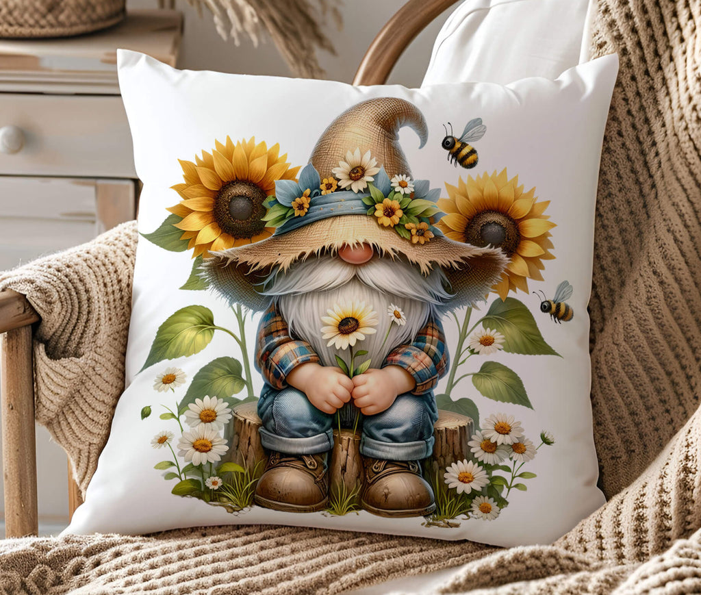 A farmhouse style bee gnome pillow featuring a cute gnome in a rustic straw hat, surrounded by sunflowers daisies, and buzzing bees, with the text "Always Bee Humble and Kind". The 18x18-inch pillow is available in white canvas or beige linen with a hidden zipper closure perfect for cottagecore spring and summer home decor - Personalized Kreation