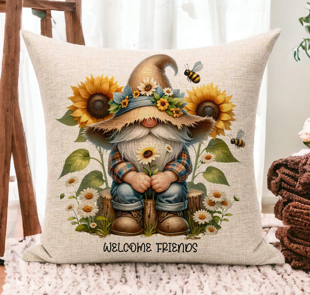 A farmhouse-style bee gnome pillow featuring a cute gnome in a rustic straw hat, surrounded by sunflowers, daisies, and buzzing bees, with the text "Always Bee Humble and Kind". The 18x18-inch pillow is available in white canvas or beige linen, with a hidden zipper closure, perfect for cottagecore, spring, and summer home decor - Personalized Kreation