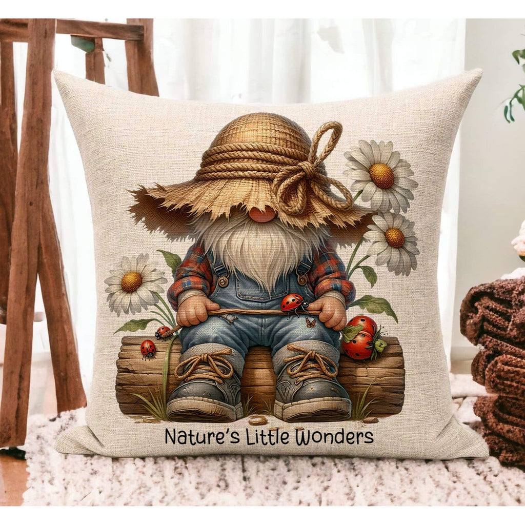 A farmhouse-style gnome pillow featuring a cute gnome with a rustic straw hat, sitting on a log, surrounded by daisies and ladybugs, with the text "Nature’s Little Wonders". The 18x18-inch pillow is available in white canvas or beige linen, with a hidden zipper closure, perfect for cottagecore, farmhouse, and nature-inspired home decor - Personalized Kreation
