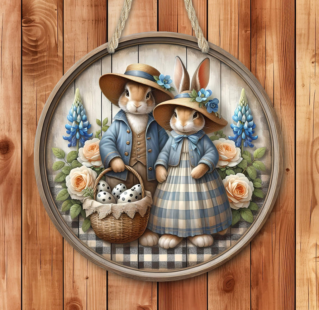 A vintage-style Easter bunny sign featuring a charming bunny couple in blue outfits, holding a basket of Easter eggs, surrounded by flowers, on a wooden background. This rustic farmhouse-style wall art is perfect for Easter, spring, and cottagecore decor - Personalized Kreation